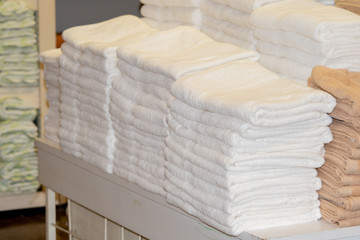 Fototapeta na wymiar Clean White Towels and Brown Towels on shelf
