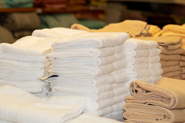Fototapeta na wymiar Clean White Towels and Brown Towels on shelf