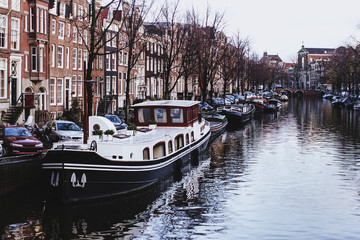Fototapeta na wymiar Channel in Amsterdam Netherlands Boat houses river european city landscape