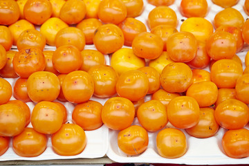 Fresh orange persimmons at fruit shop