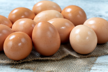 Raw organic brown farm raised eggs on burlap cloth