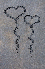 Heart shapes balloons on black sand beach