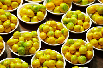 Tangerines in bucket at fruit shop