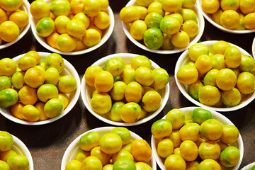 Tangerines in bucket at fruit shop