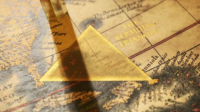 Bermuda triangle marked with golden ink on a vintage map. Compass malfunction.