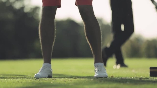 Golfer hitting an iron shot in slow motion.