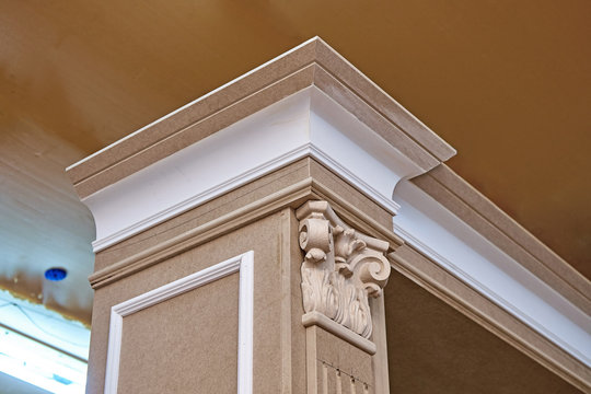 Mdf cabinet carcass with moldings and wooden carved chapiter. Wooden furniture manufacturing process