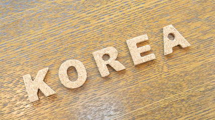 Cork Text Block of "Korea" on wooden table