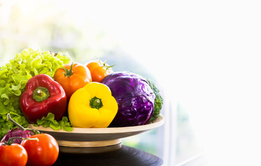 A wood basket of varity vegetable - Bell pepper, tomato, purple cabbage, broccoli, onion and green lettuce. Healthy and diet food. Free copy space on right for text and design.