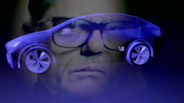 Close up reflection of industrial engineer designing an electric car using 3D software (variation with eye glasses)