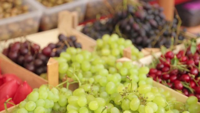 Counter with grapes, peaches and watermelons. Fruit market in Montenegro, Kotor.