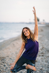 Young healthy Yoga woman practicing yoga pose on the beach at sunrise, benefits of natural environments for physical, spiritual, healthy, relaxing concept.