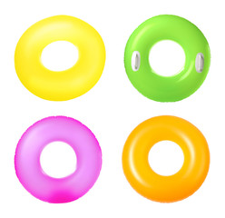 Set of bright inflatable rings on white background