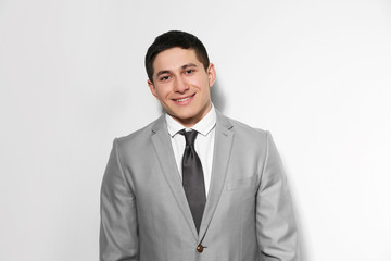 Portrait of young businessman on light background
