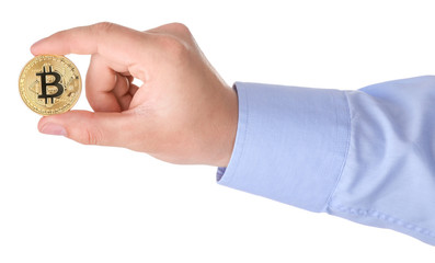 Man holding golden bitcoin on white background, closeup