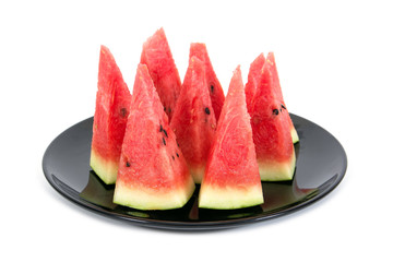 Slice watermelon in plate isolated on white background. Slice red watermelon in black plate isolated