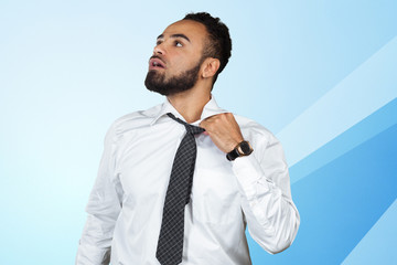Young african guy in white shirt standing untied after hard working day