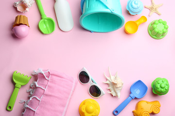 Flat lay composition with bright beach toys on color background. Space for text