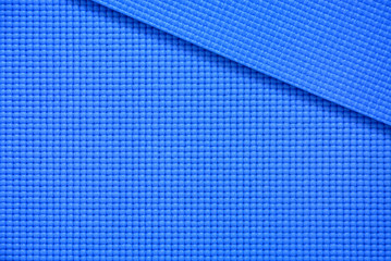 close up roll blue color yoga mat texture background,top view, copy space, healthy lifestyle, sport and  exercise concept