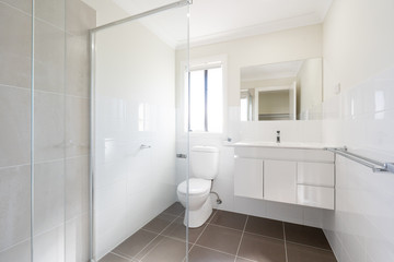 Fototapeta na wymiar Australian New Home Bathroom Interior with shower, vanity and toilet