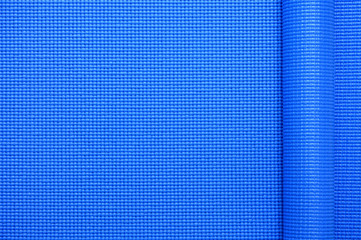 close up roll blue color yoga mat texture background,top view, copy space, healthy lifestyle, sport...