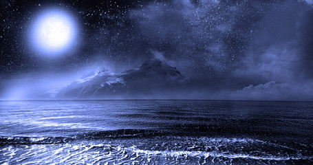 Night ocean and rocky island against the starry sky and the full moon