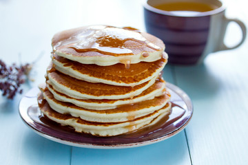 Healthy breakfast, homemade classic pancakes with caramel syrup.