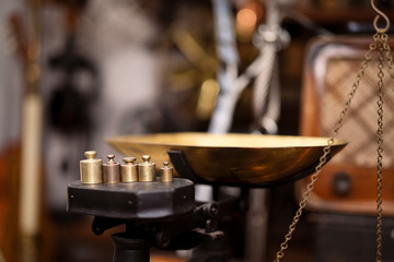 Old fashioned weights or rusty weights are on balance scale. Many kind of colorful weights used in the past. Isolated weights in vintage style with bright on background. Royalty high quality image.