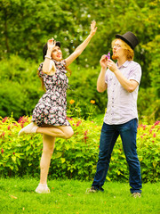 Obraz premium Couple blowing bubbles outdoor