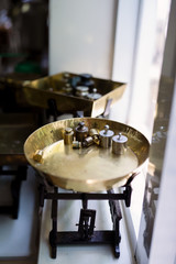 Old fashioned weights or rusty weights are on balance scale. Many kind of colorful weights used in the past. Isolated weights in vintage style with bright on background. Royalty high quality image.