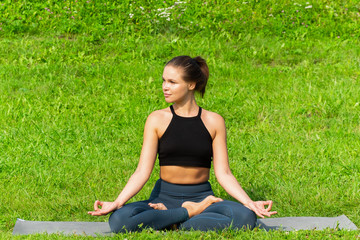 Woman on a yoga, relax in the park.