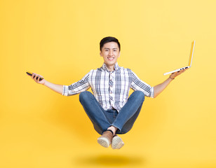 young man holding phone and floating in the air