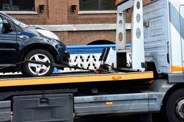 New car transported on white Tow track