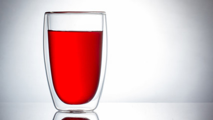 Red liquid on a white background, juice or tea.