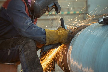 sparks from the Stripping machine in the processing of the root weld in the welding of pipeline...