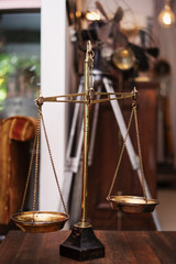 Many kind of old fashioned balance scales on wooden table. Colorful ancient balance scales in vintage background, isolated. the symbol of Lawyer. Royalty high quality free stock image.