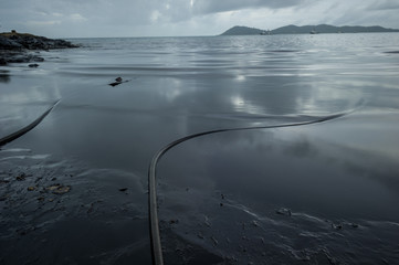 Crude oil along the beach of Ao Phrao after a nearby oil spill in Gulf of Thailand.
