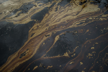Oil sludge contaminating the sea during the oil spill disaster in Samet Island, Rayong, Thailand.