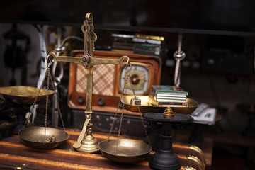 Fototapeta na wymiar Many kind of old fashioned balance scales on wooden table. Colorful ancient balance scales in vintage background, isolated. the symbol of Lawyer. Royalty high quality free stock image.