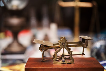Many kind of old fashioned balance scales on wooden table. Colorful ancient balance scales in vintage background, isolated. the symbol of Lawyer. Royalty high quality free stock image.