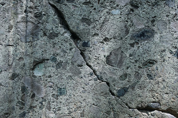 Crack on the surface of the stone close-up, background