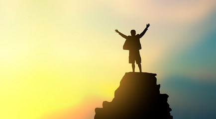 Obraz na płótnie Canvas silhouette of man on mountain top over sky and sun light background,business, success, leadership, achievement and people concept