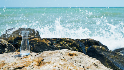 Glass bulb. Sea shore. Waves hit the stones.