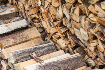 Beautiful countryside view of timber firewood stacked in a big stack near home in a countryside village home. 