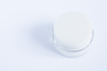 Top view of Daily  face cream. Organic natural cosmetic product. Jar with cream and flowers on white background. Woman's skincare routine.Cope space.