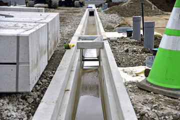 Fototapeta na wymiar Construction site - residential land development : burial of u-shaped gutter