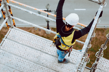 workers work removing a scaffolding at high altitude in Oviedo, Asturias, Spain.