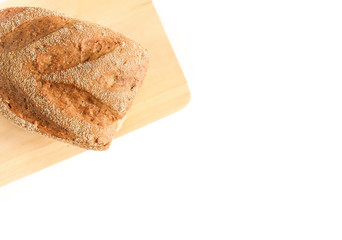 Top view of freshly baked bread on wooden cutting board isolated on white background. Bread on Slicing board. Copy space. Bakery, food concept. 