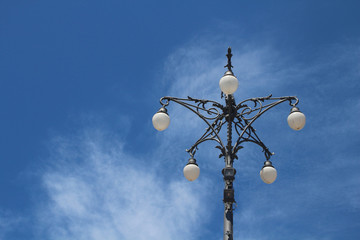 Fototapeta na wymiar Vintage street lamp against blue sky