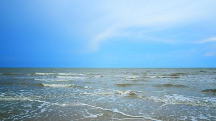 Ocean wave and blue sky background in rain season in Thailand